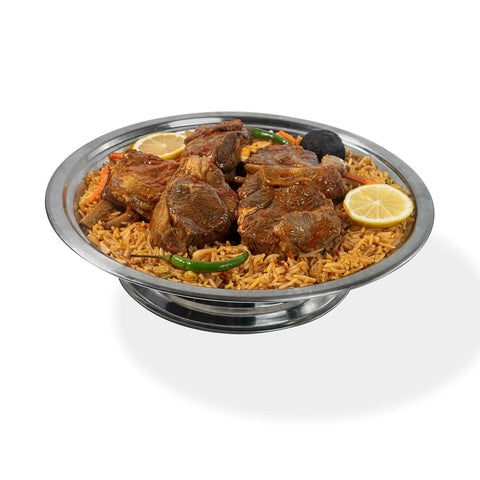 Abu Mubarak Mutton Kabsa 4-Pax platter showcasing tender bone-in mutton portions served over a bed of golden spiced basmati rice with green chilies and lemon garnishes.
