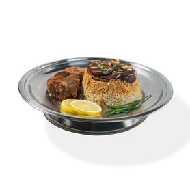 Abu Mubarak Mutton Maqlubah for one person, featuring tender pieces of spiced mutton and golden fries on a bed of aromatic basmati rice, garnished with lemon and fresh vegetables on a silver platter.